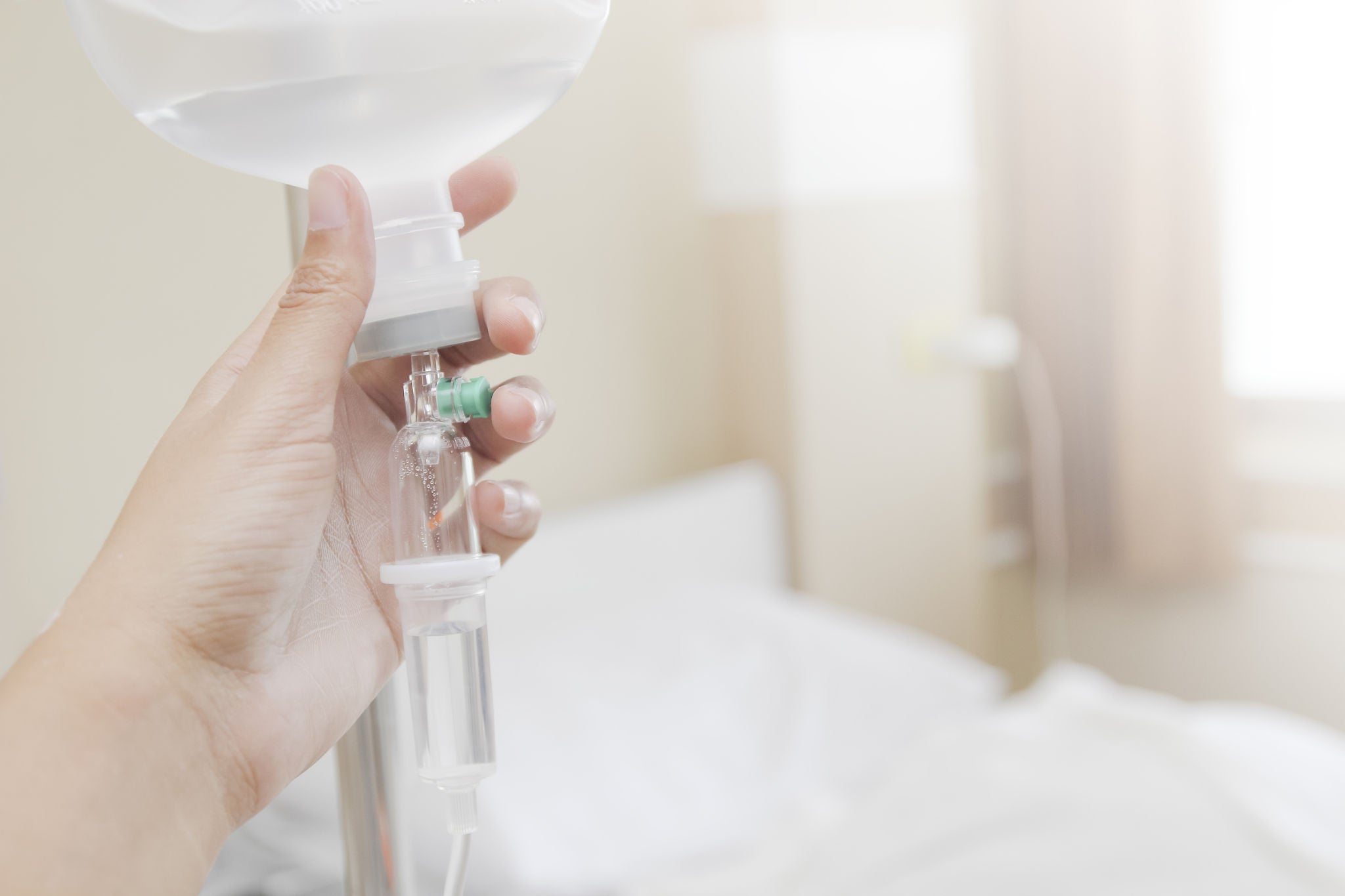 Close up saline IV drip for patient and Infusion pump in hospital.